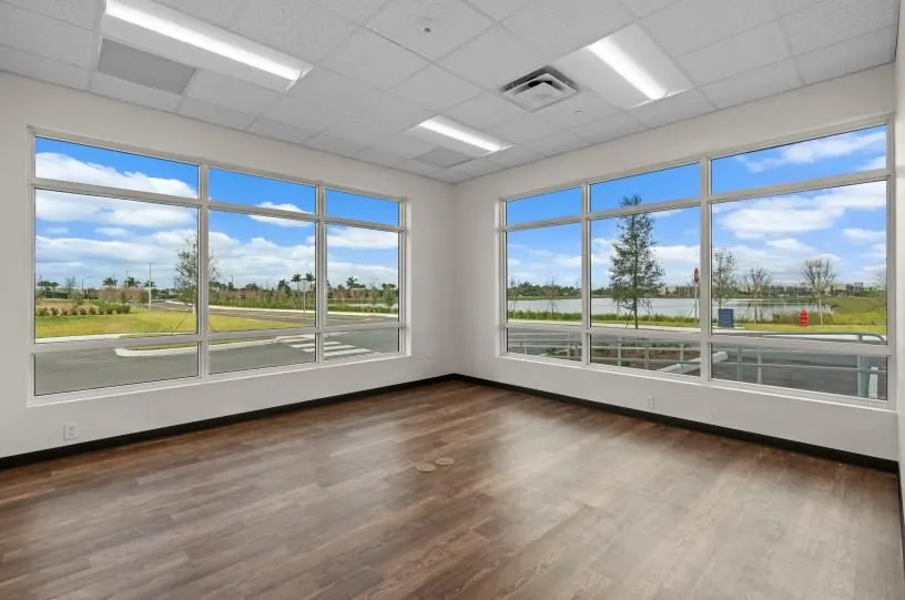Finished spec suite office — corner windows overlooking the lake