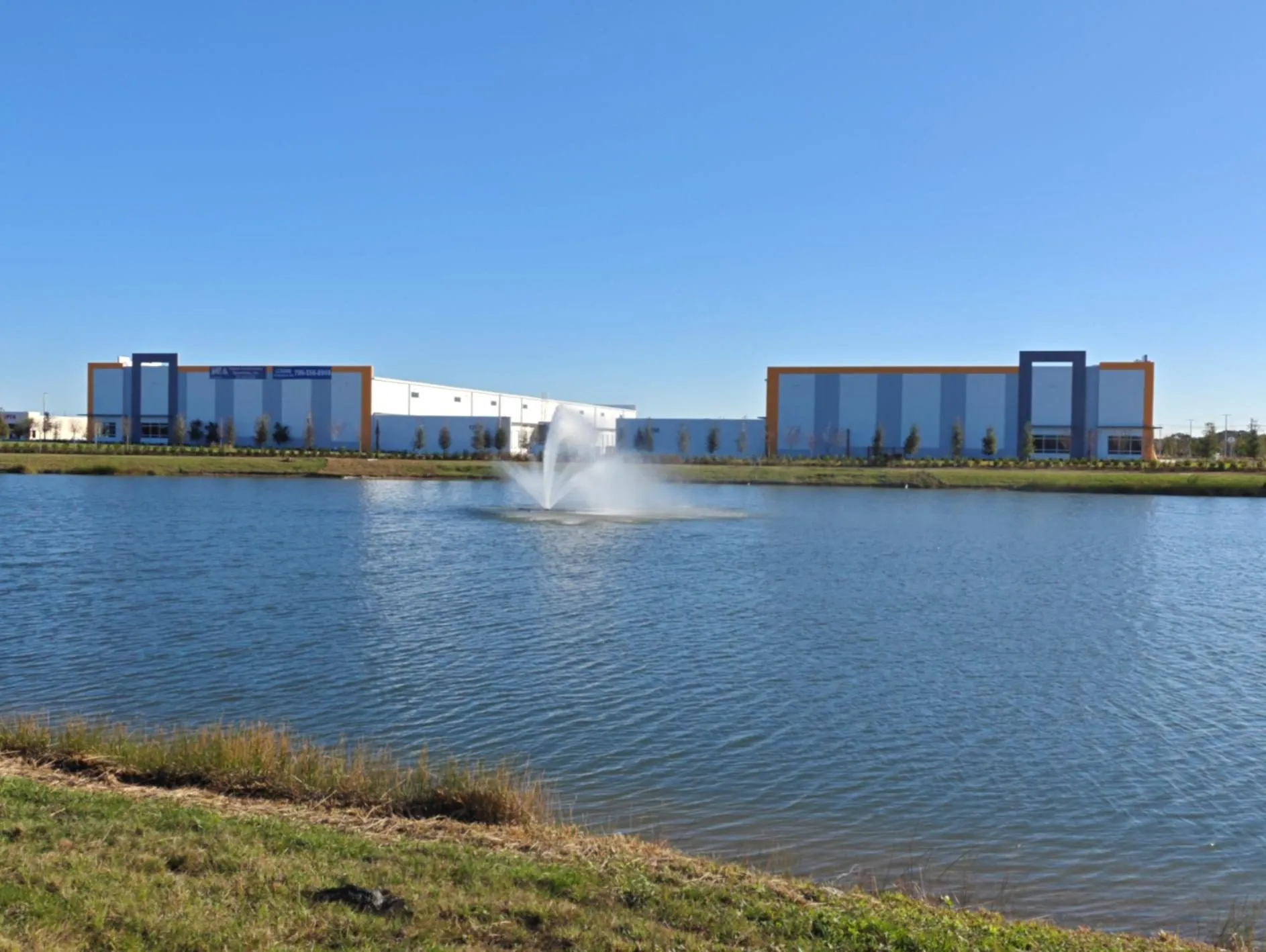 Buildings 1 and 2 seen across the lake and fountain from Village Parkway